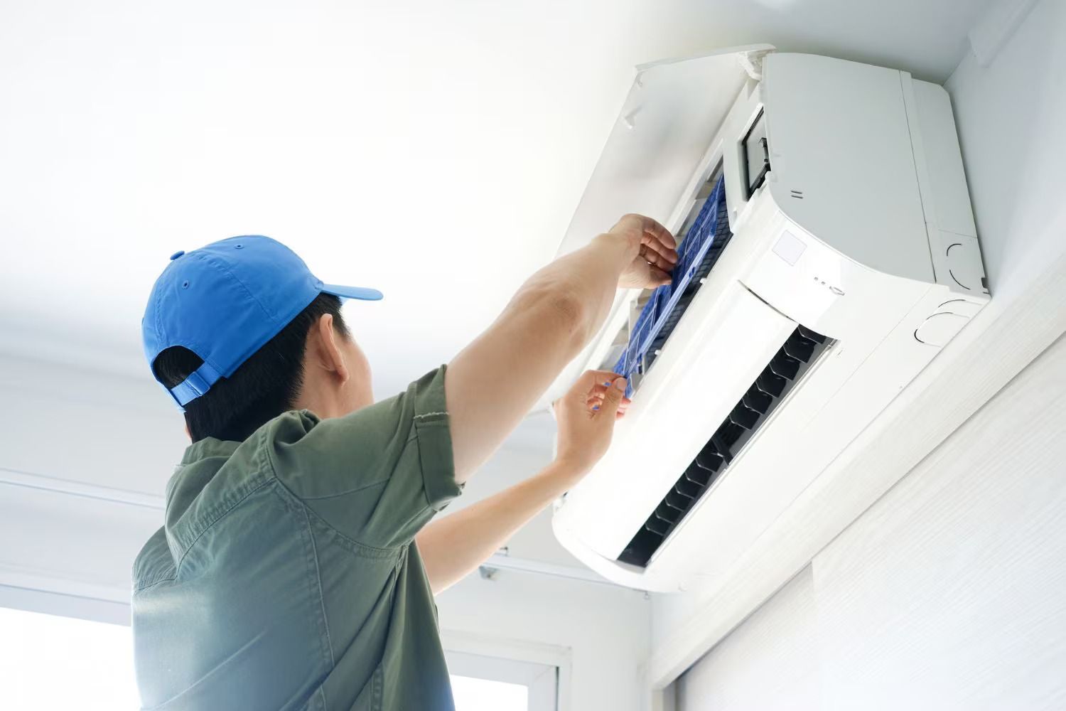 AC technician providing air conditioner repair and maintenance service